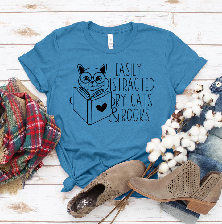 Heather Blue t-shirt with a cat and book graphic and text &
