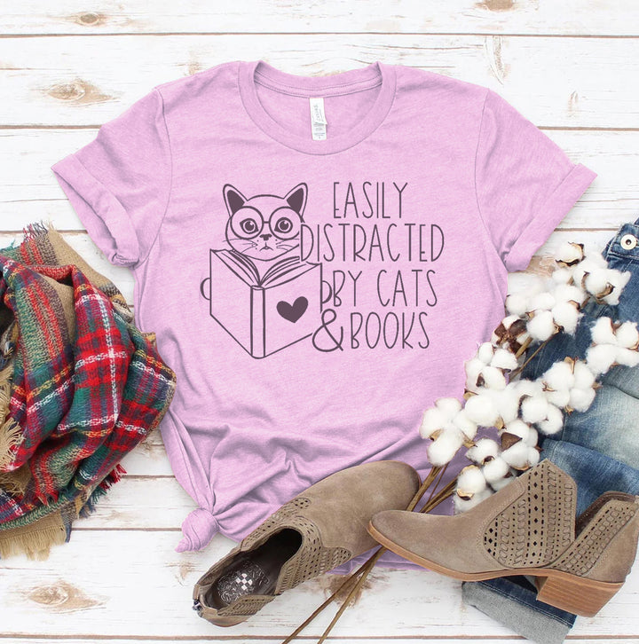 Purple t-shirt with a cat and book design and text &