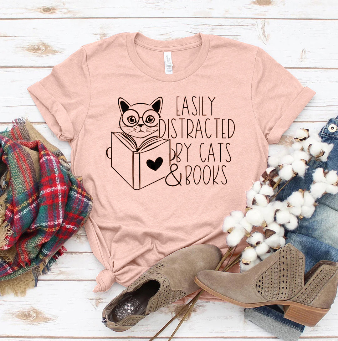Peach t-shirt with cat and book graphic and text &