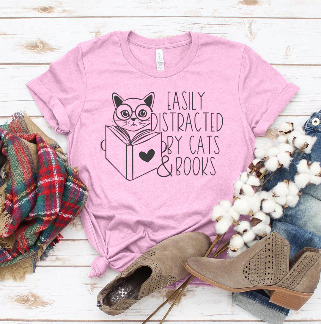 Light Pink t-shirt with a cat and book graphic and text &