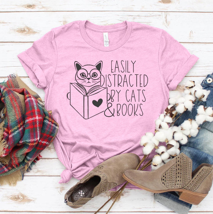 Light Pink t-shirt with a cat and book graphic and text &