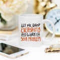 Coffee Mug featuring the quote 'Let Me Drop Everything And Work On Your Problem' on a stylish desk.